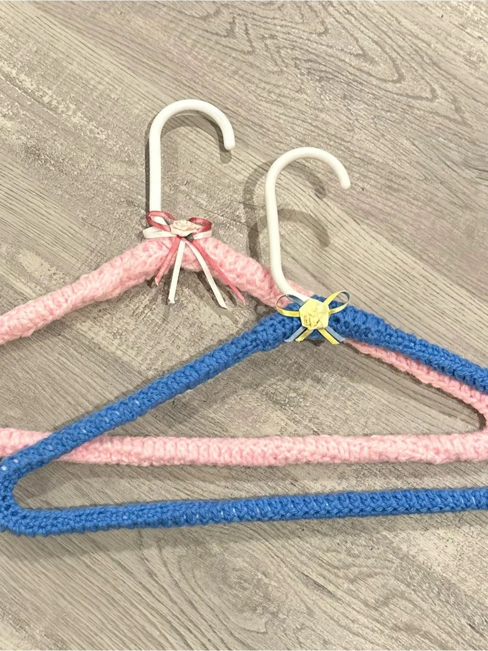 Handmade Pink and Blue Yarn-Covered Closet Hangers with Decorative Bows